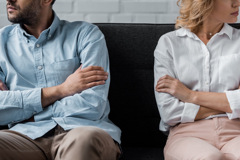 cropped shot of couple sitting on couch after quarrel Collaborative divorce Hugh O'Donnell Kansas City AdobeStock_235172963